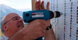 Photo of man drilling into the Obermuttern Town Message Board