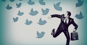 Image of Businessman being swarmed by Twitter birds