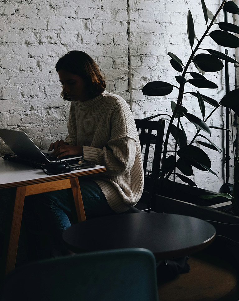 Person working in a cozy café, storytelling