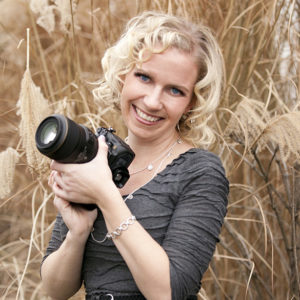 photo of Karli Moore in a field holding a camera