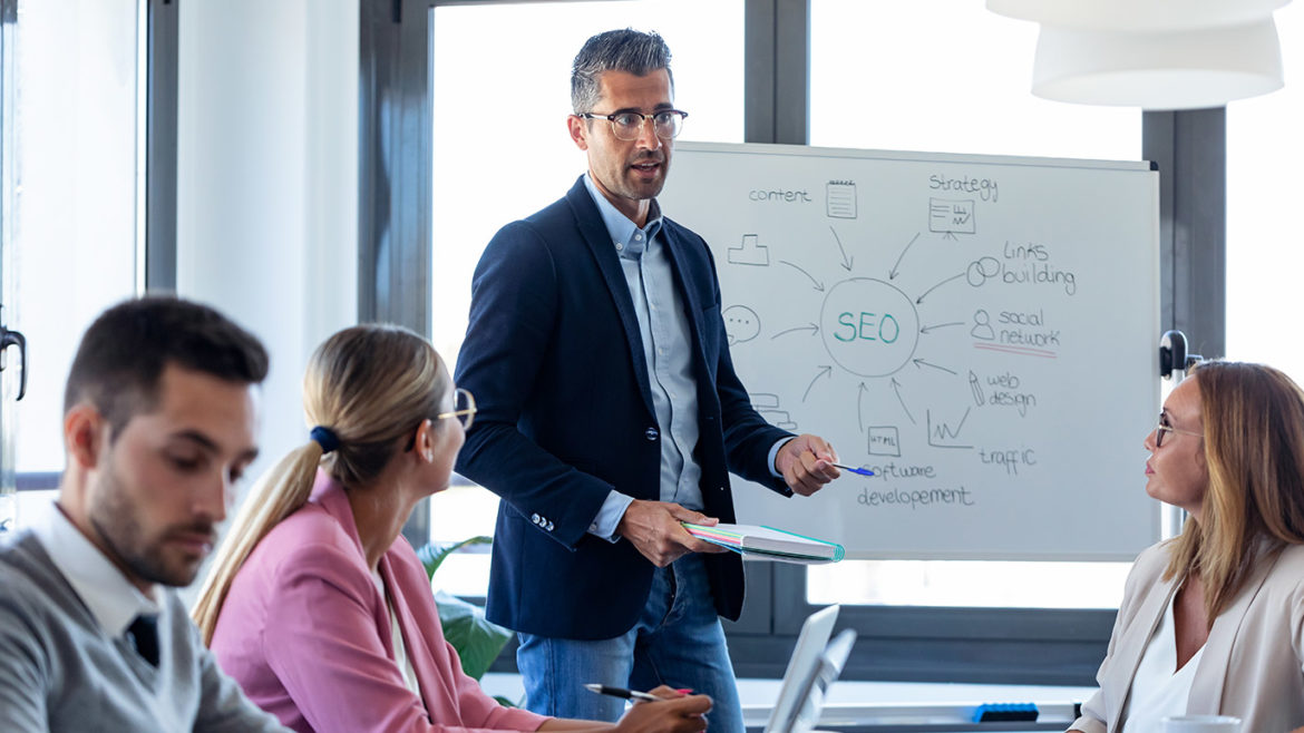 group of people sitting around a conference room table talking about SEO