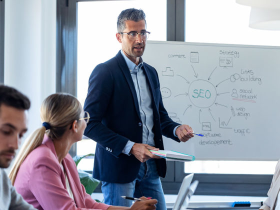 group of people sitting around a conference room table talking about SEO