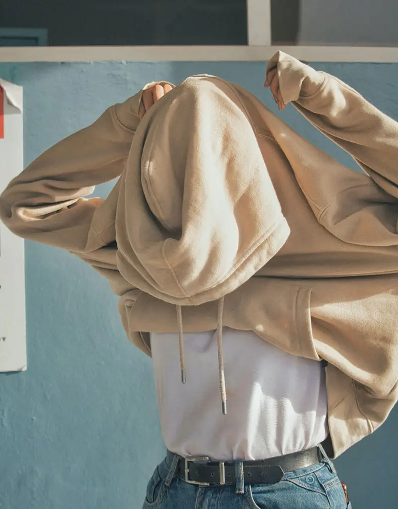 a person wearing a hoodie image altered with Photoshop AI