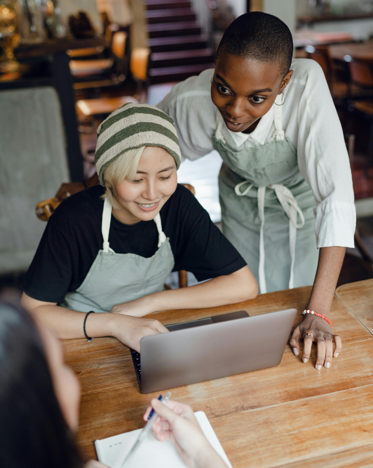 Small business owners discussing over a computer.