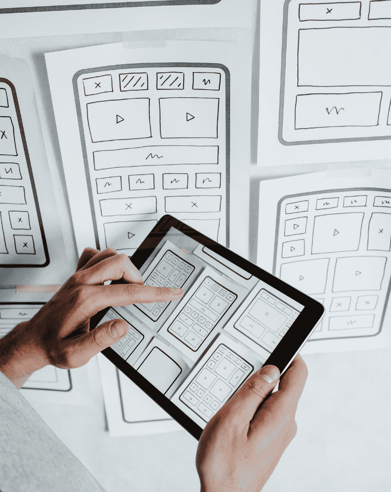 Person holding iPad in front of wall